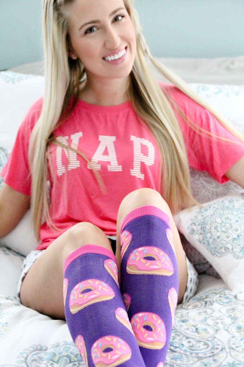 girl wearing funky socks in bed