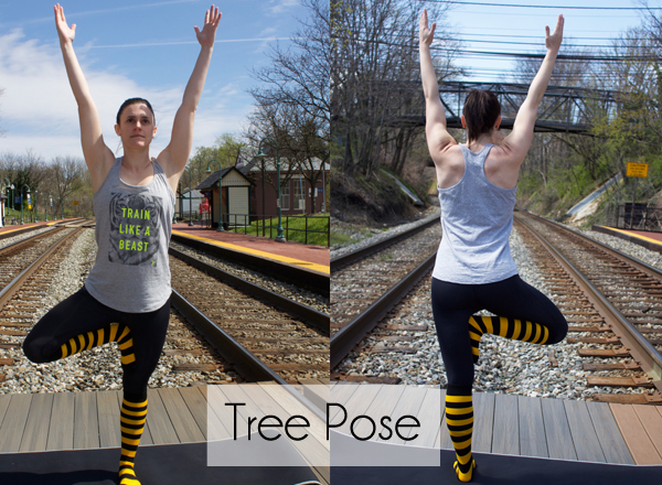 young woman doing yoga tree pose outdoors